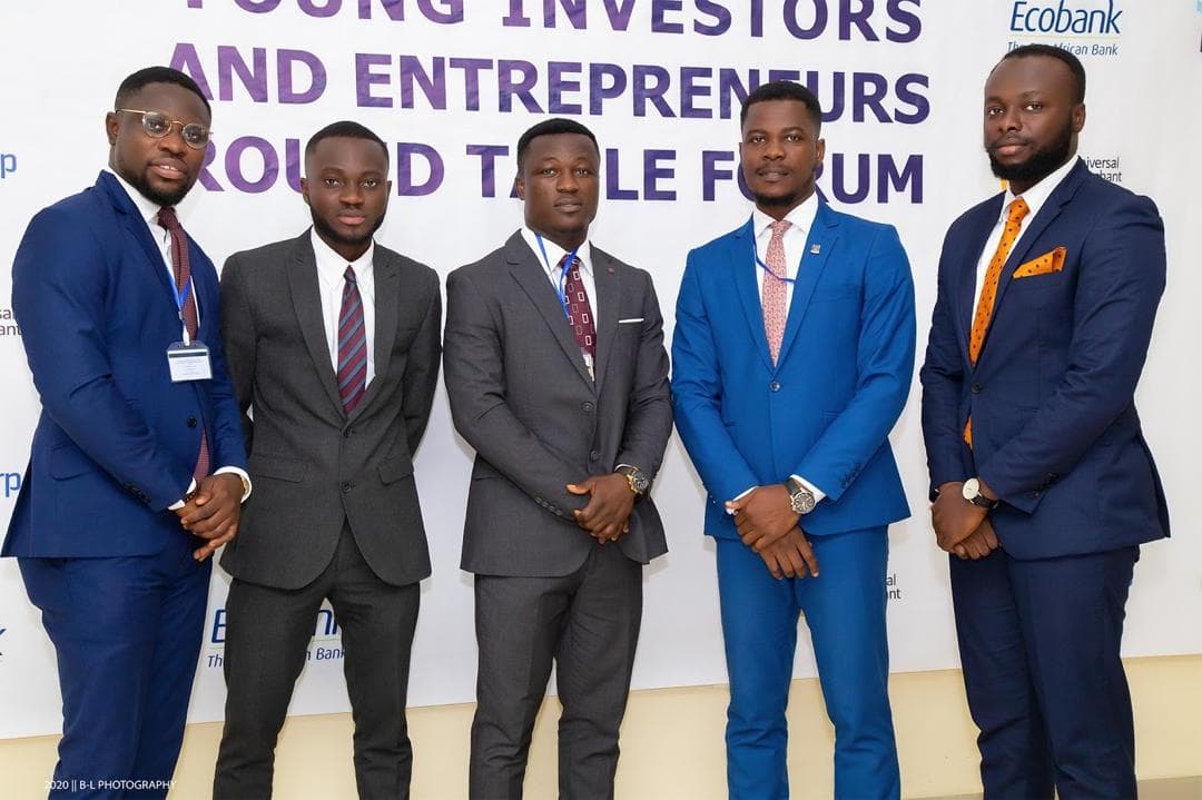 Five GIA members in suits in front of the Young Investors & Entrepreneurs Round Table Forum backdrop