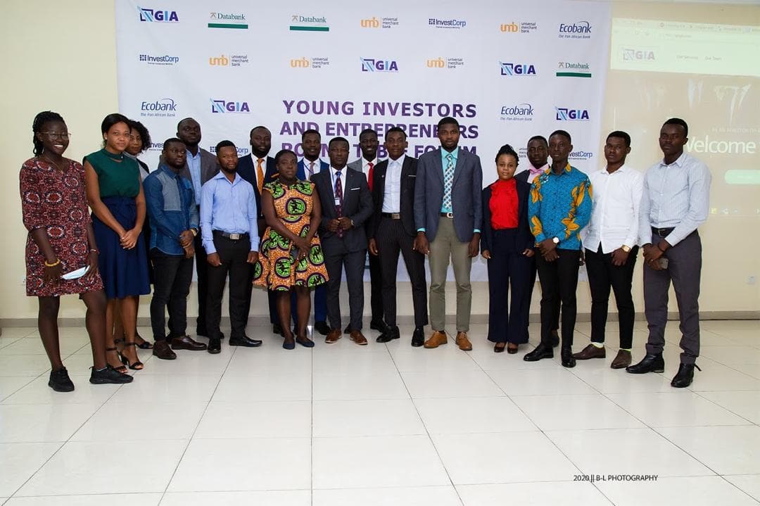 GIA members and guests in front of the Young Investors & Entrepreneurs Round Table Forum backdrop